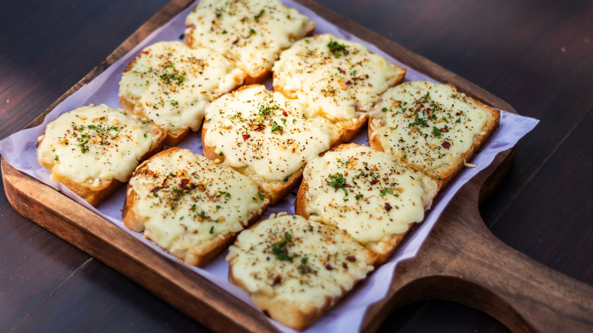 brown and white bread on brown wooden tray