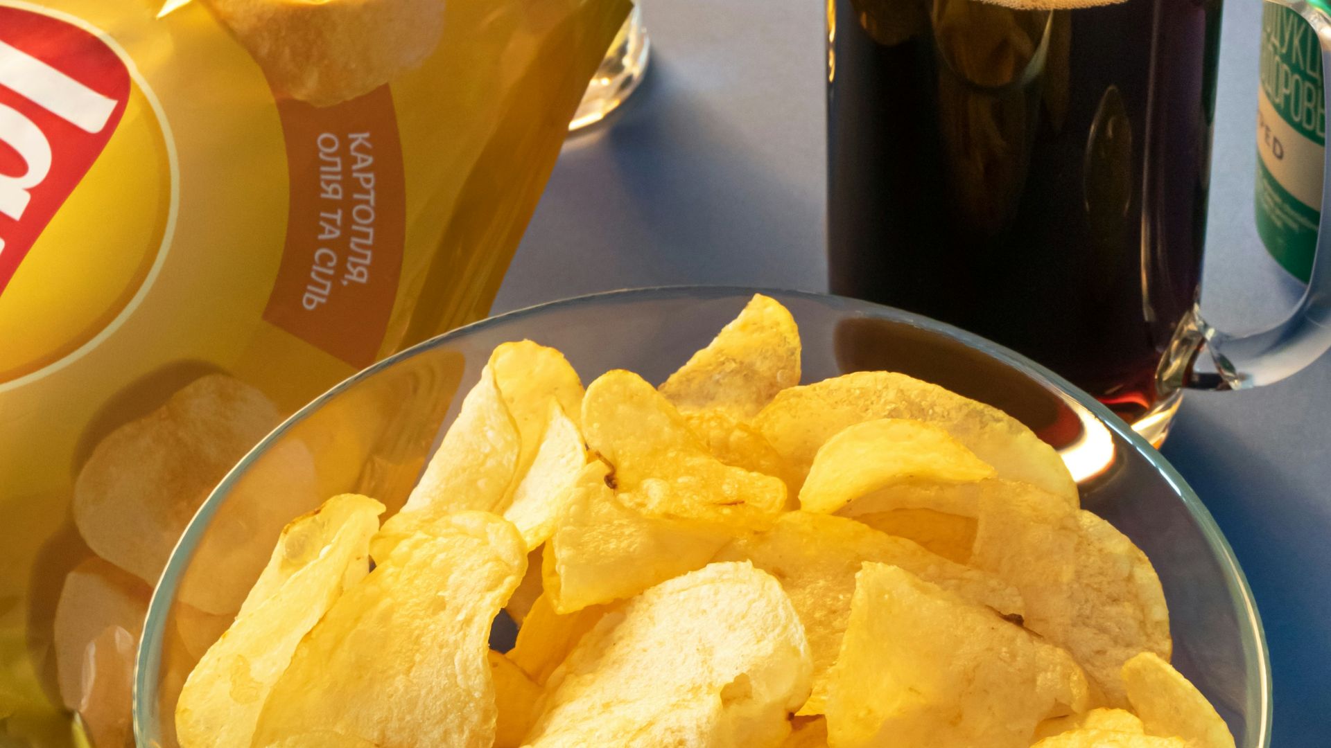 clear drinking glass beside brown bread on blue ceramic plate