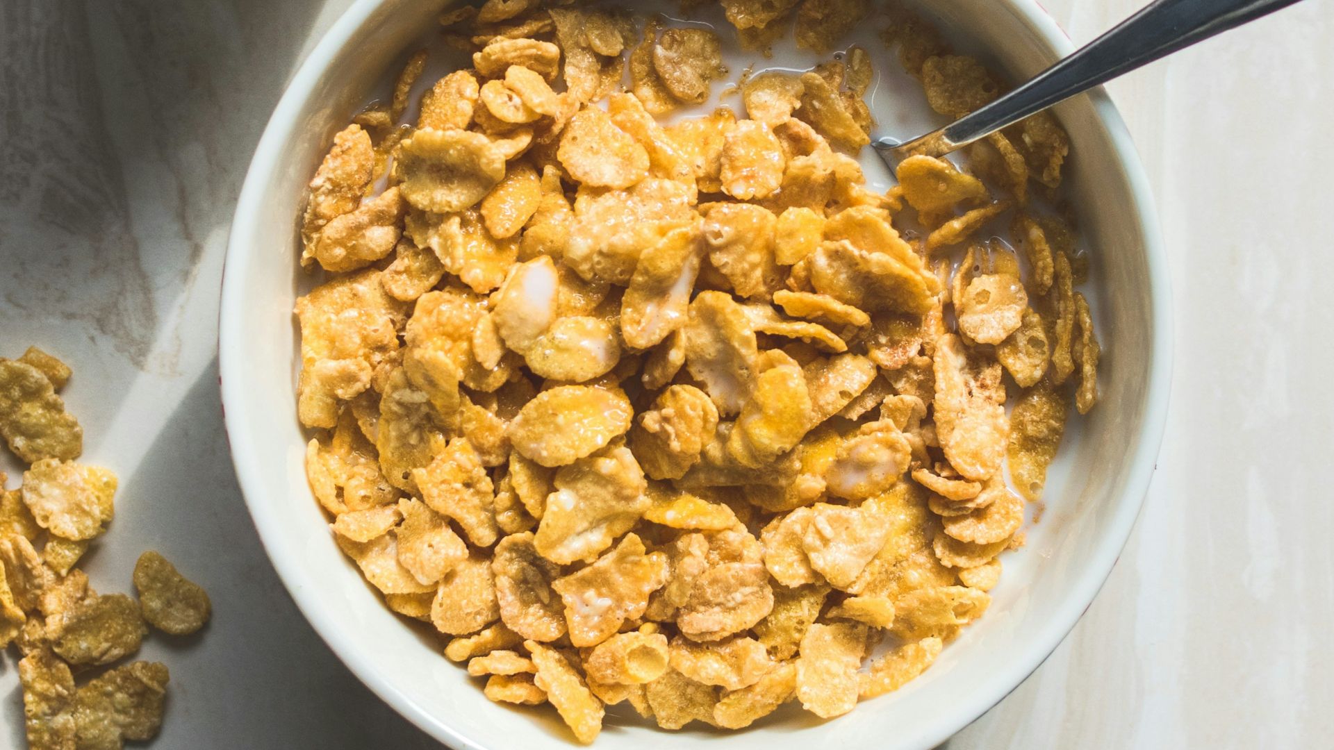 ceramic bowl filled with cereals and spoon