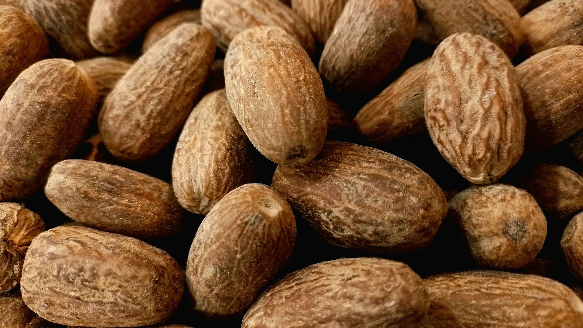 a pile of almonds sitting next to each other