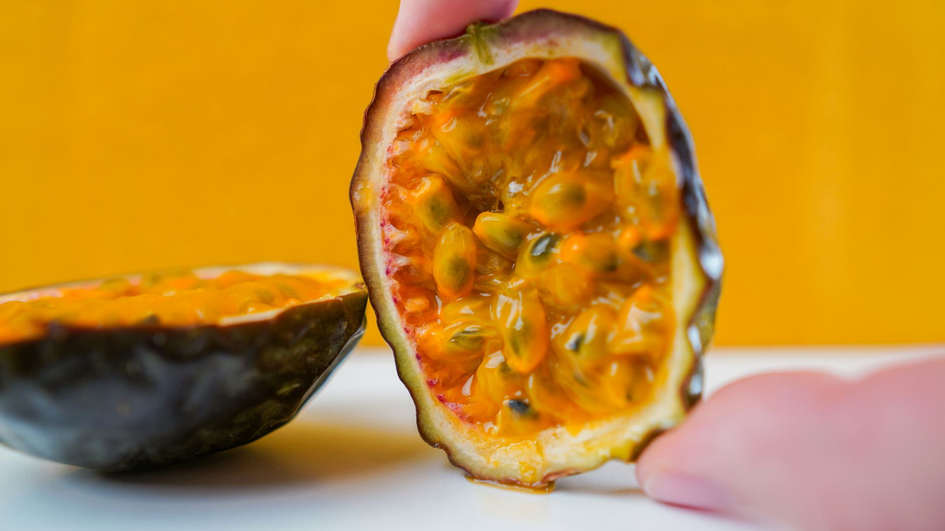 person holding sliced orange fruit