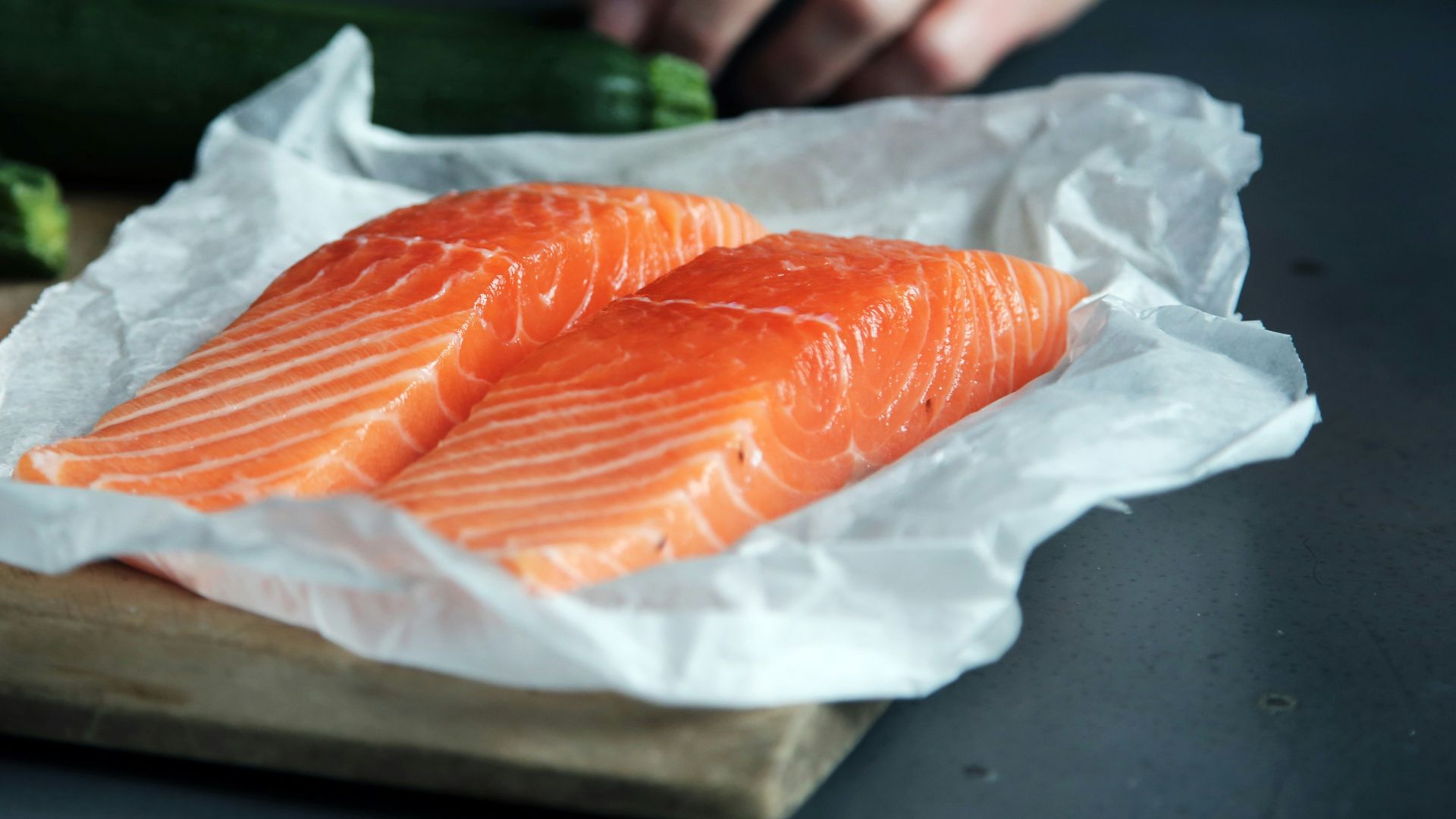 raw fish meat on brown chopping board
