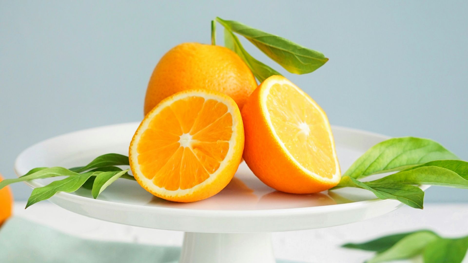 orange fruit in white ceramic plate close-up photography