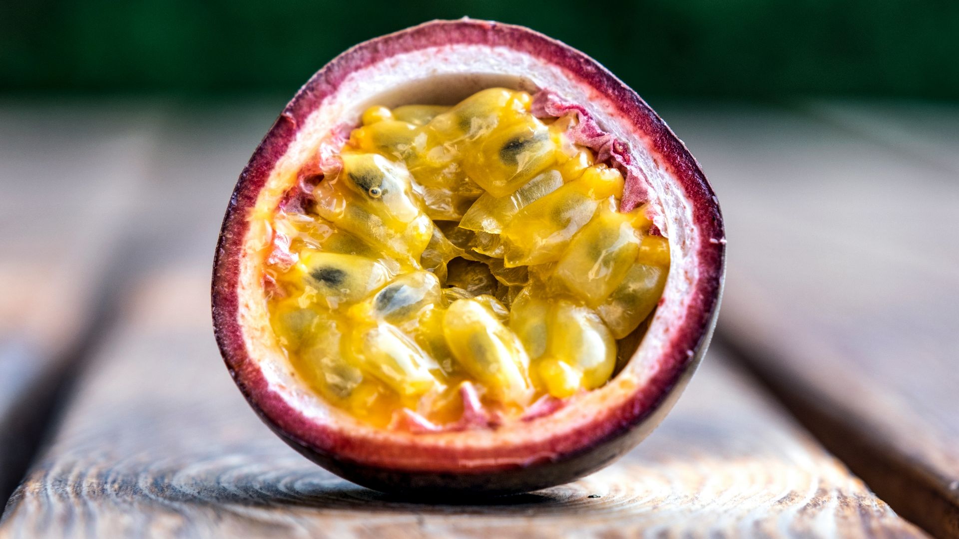 red and yellow round fruit on brown wooden table
