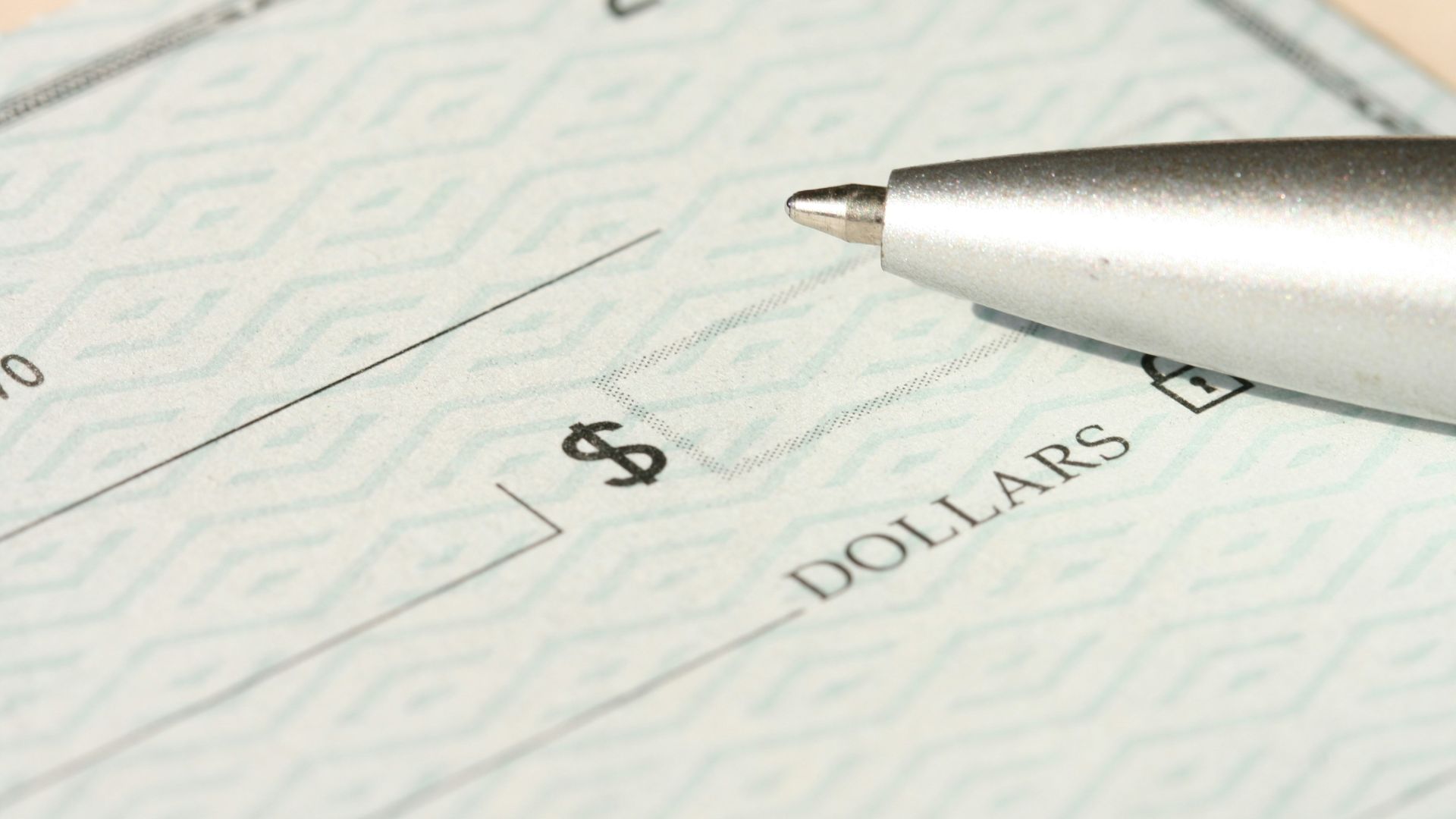 a pen sitting on top of a cheque paper