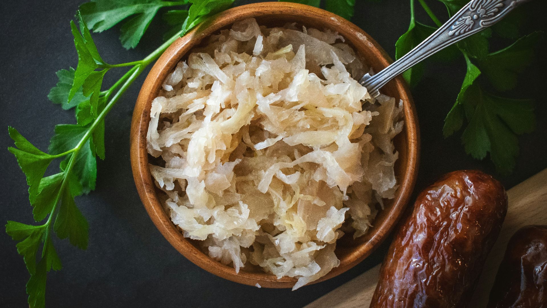 a wooden bowl filled with rice next to a spoon