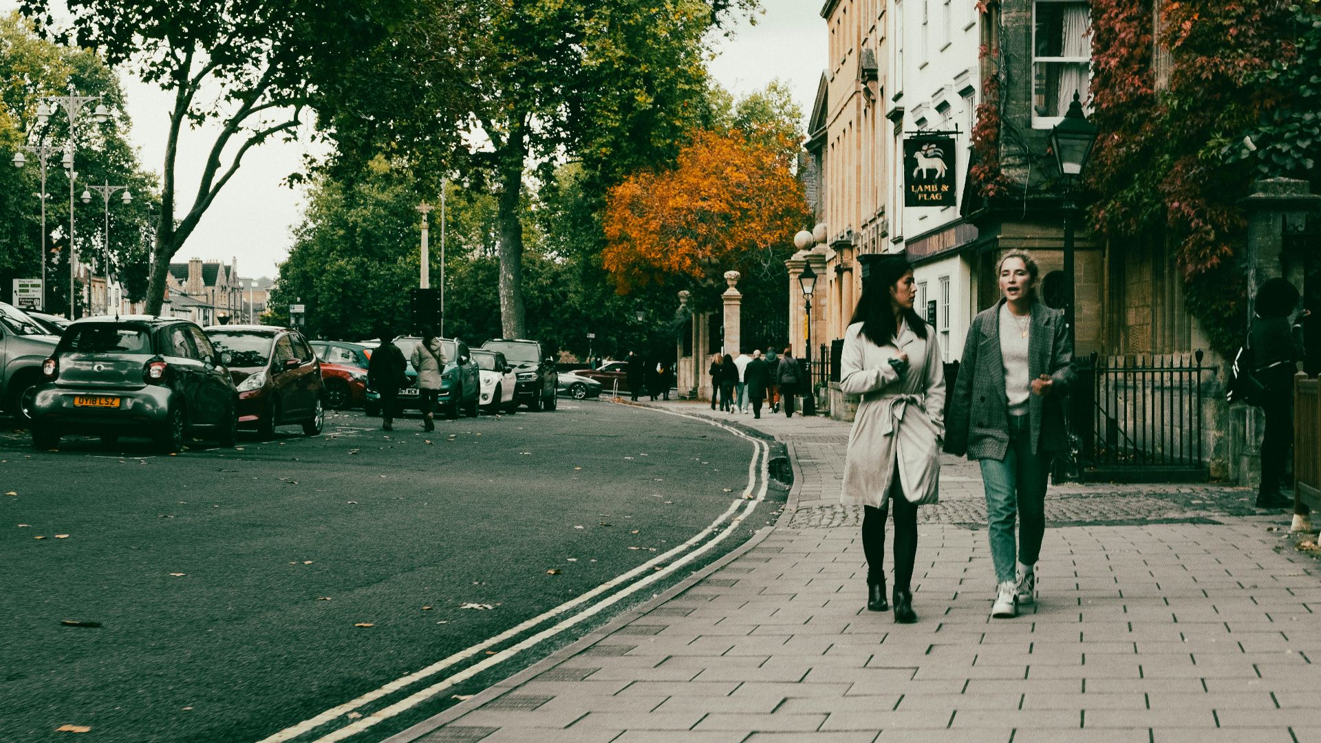 a couple of people walking down a street