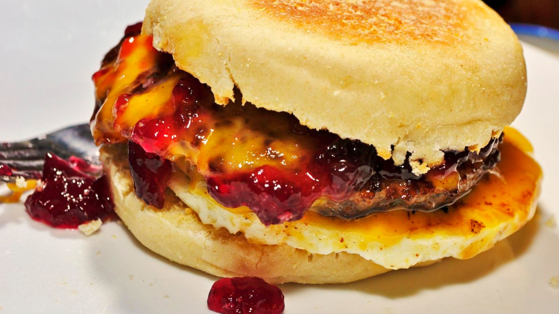 File:Sausage, egg and cheese on a muffin, with jelly.jpg