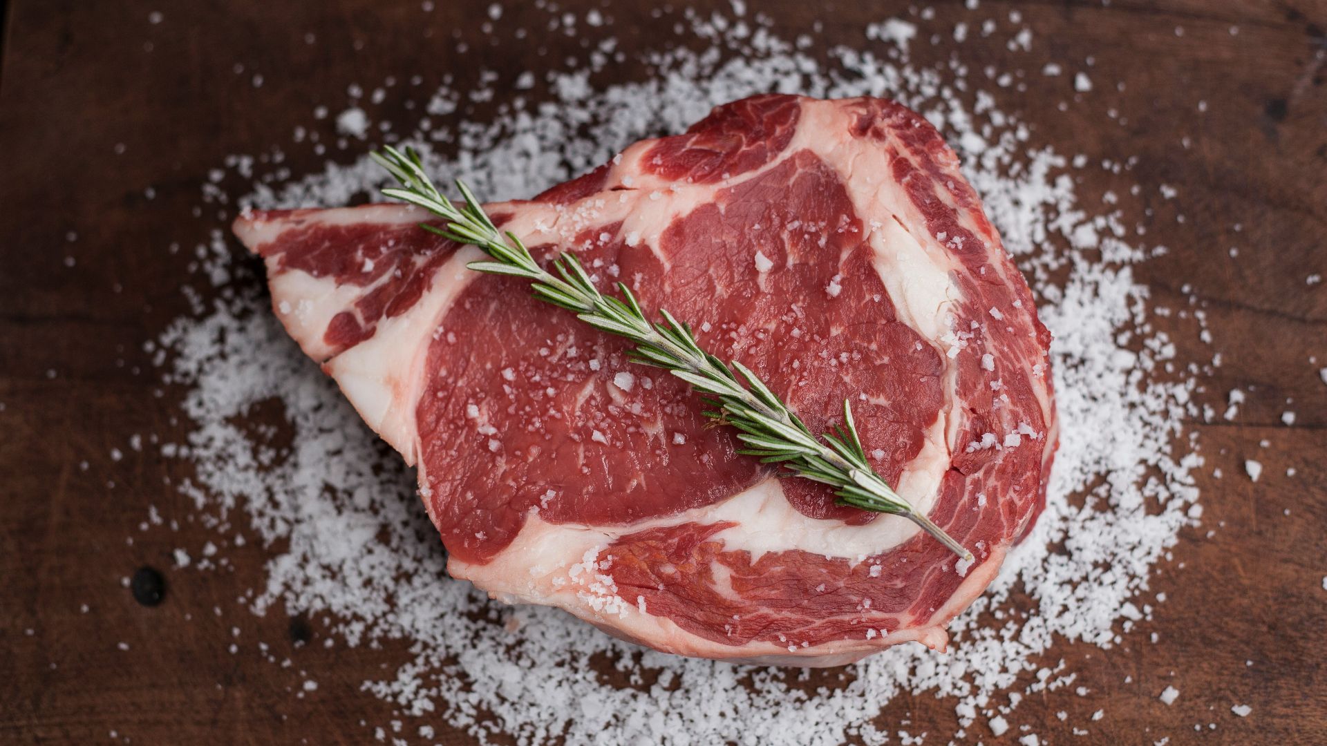 raw meat on brown wooden table