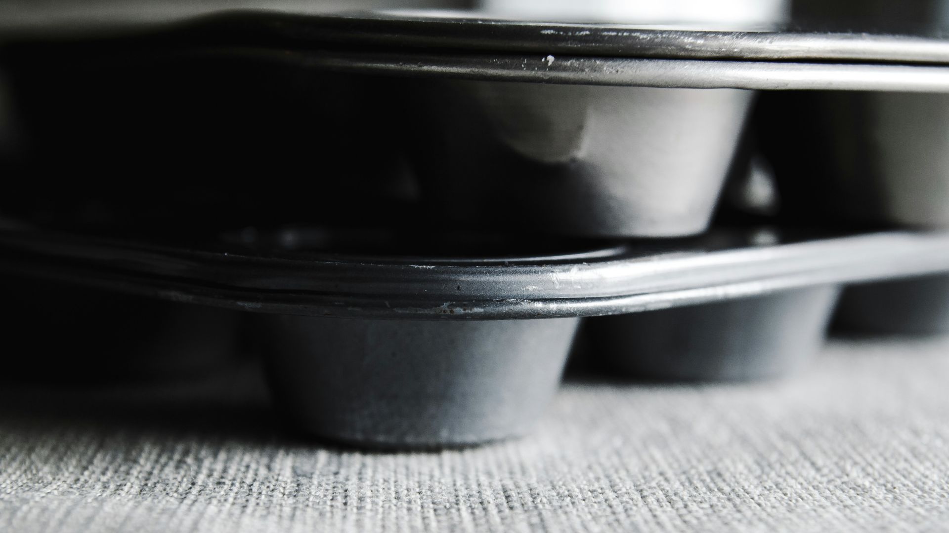 a row of black cups sitting on top of a table