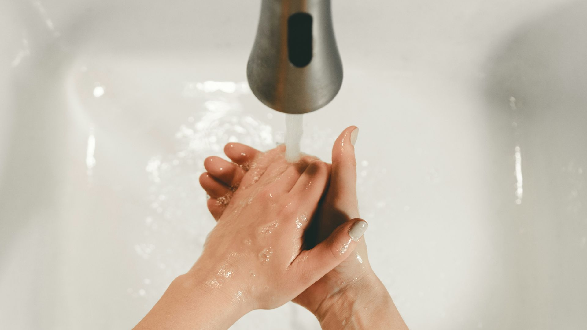 persons feet on white bathtub