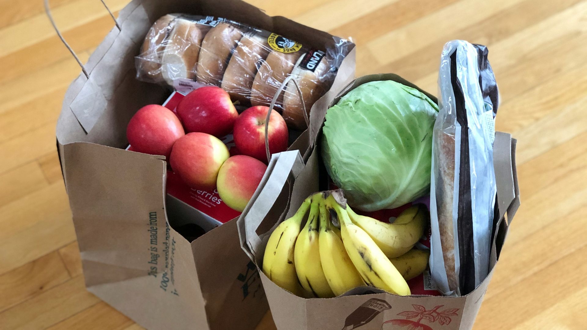apples and bananas in brown cardboard box