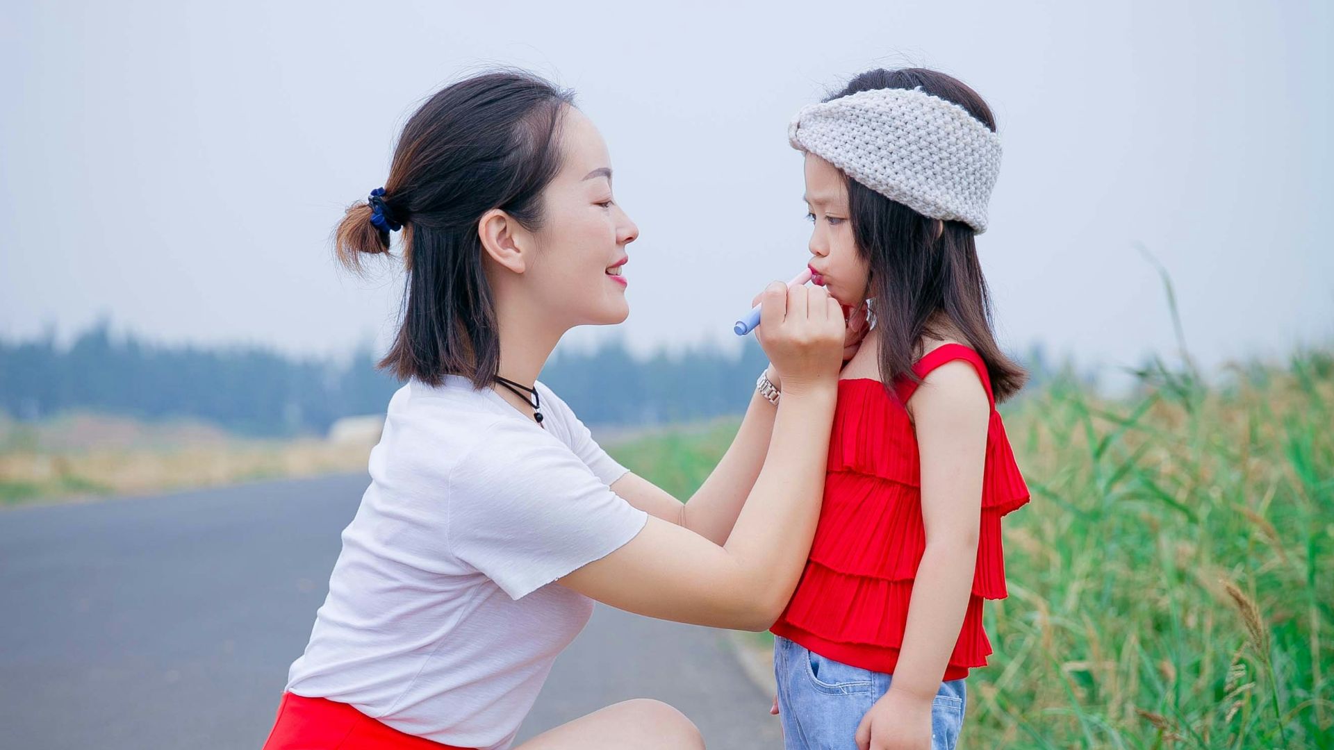 a person and a child on a road