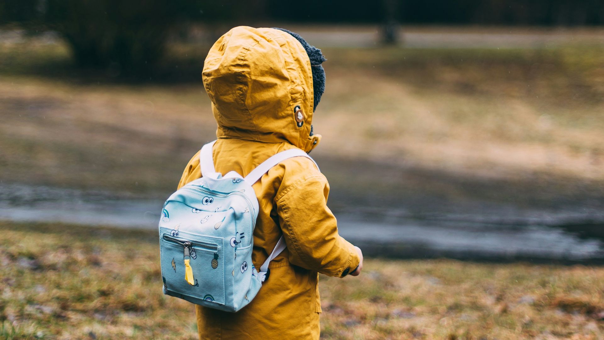 shallow focus photo of toddler walking near river