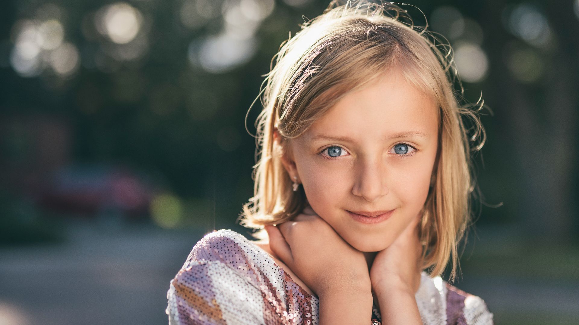 selective focus photography of girl in sequined white-and-pink stripe shirt