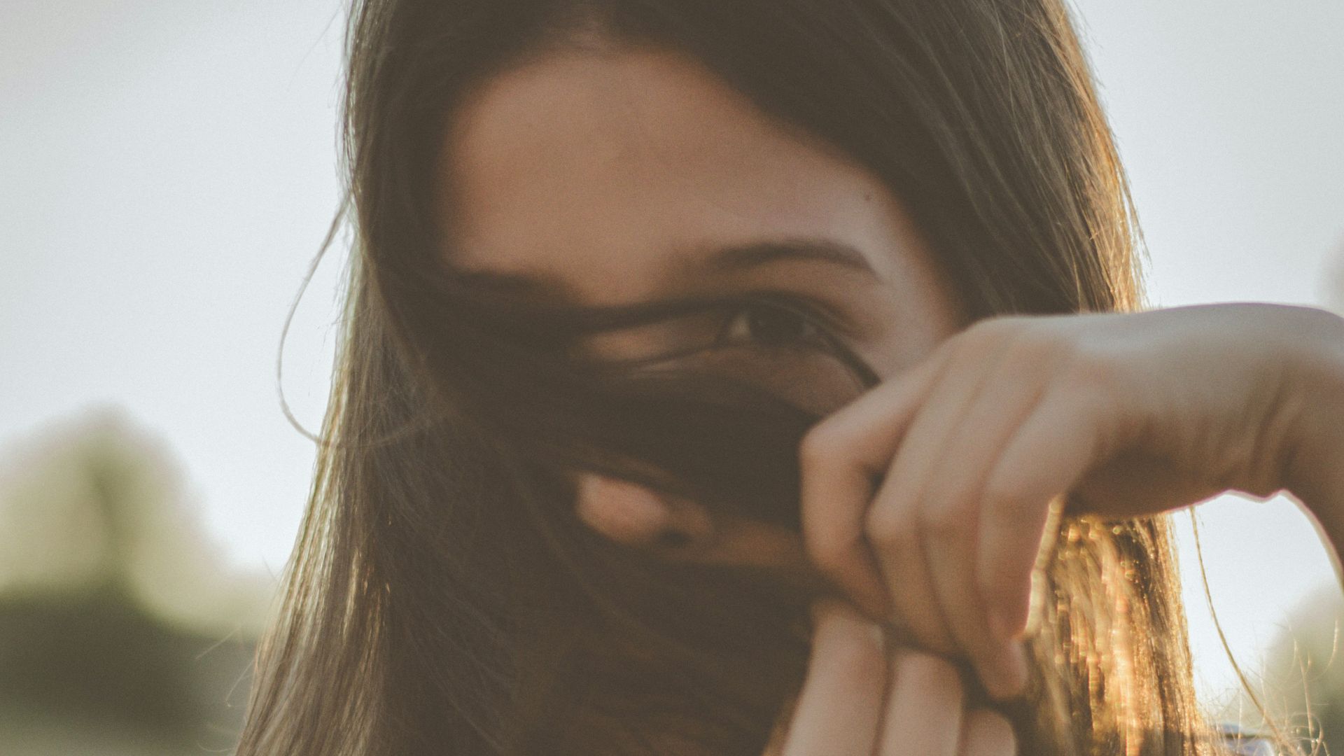 man covering her face with her hair