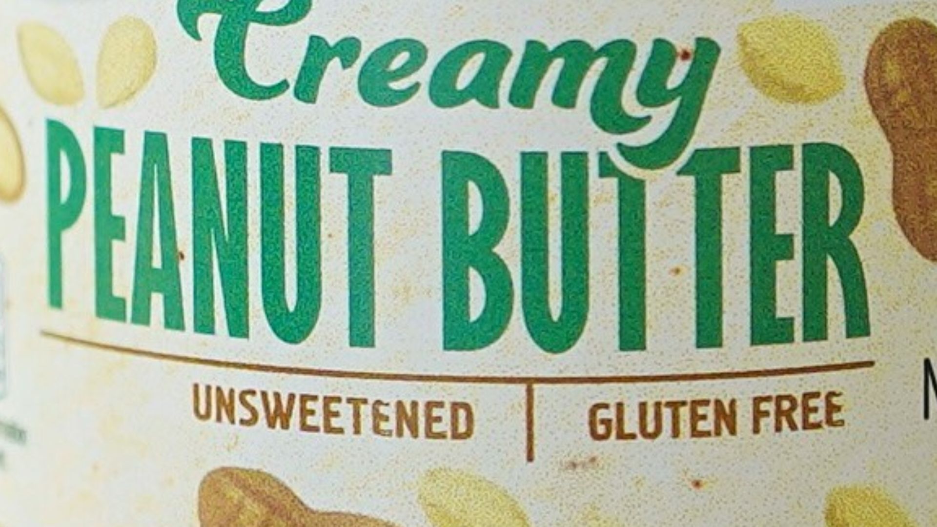 A jar of peanut butter sitting on top of a wooden table