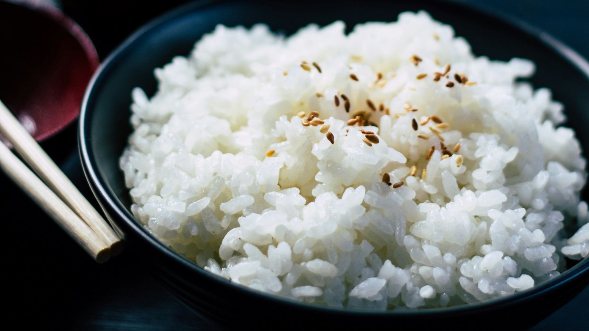 rice with sesame in black bowl
