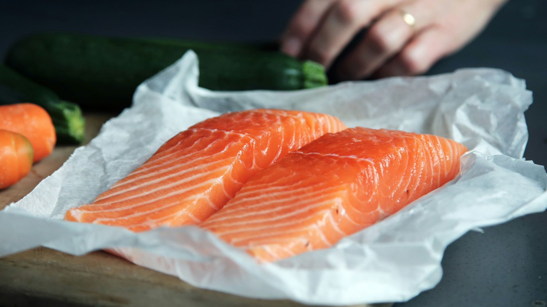 raw fish meat on brown chopping board