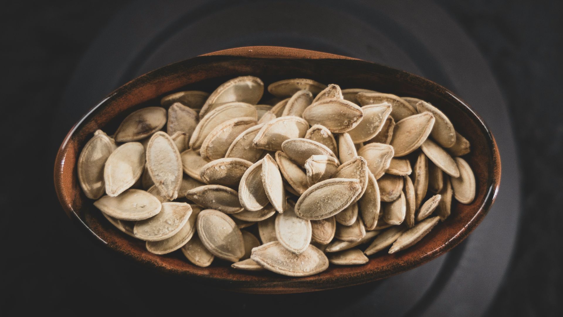 brown and white nuts on brown ceramic bowl