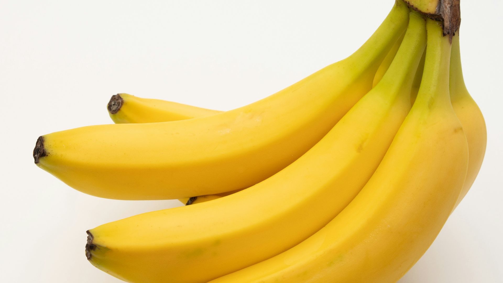 a bunch of bananas sitting on top of a white table