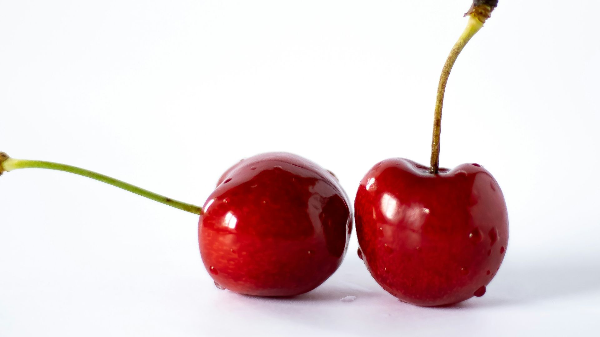 a couple of cherries sitting on top of each other