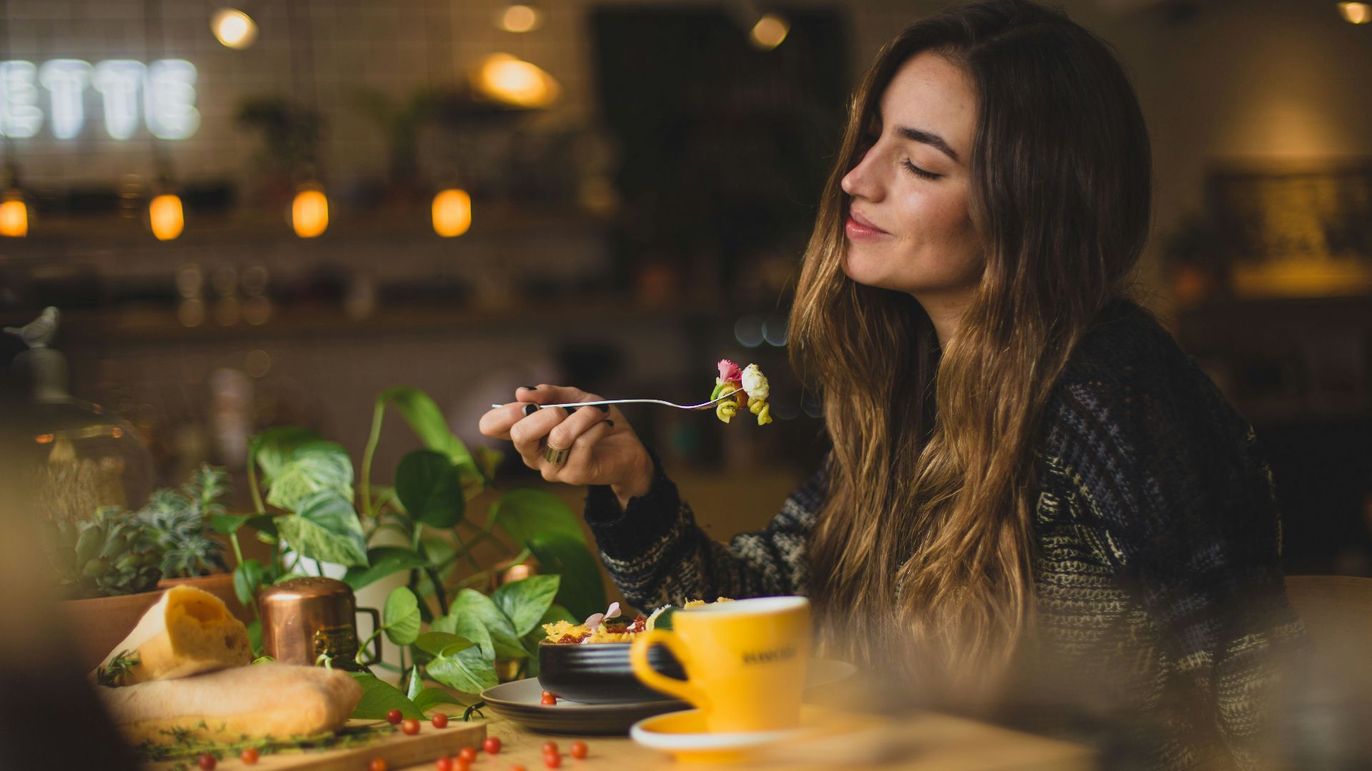 woman holding fork in front table