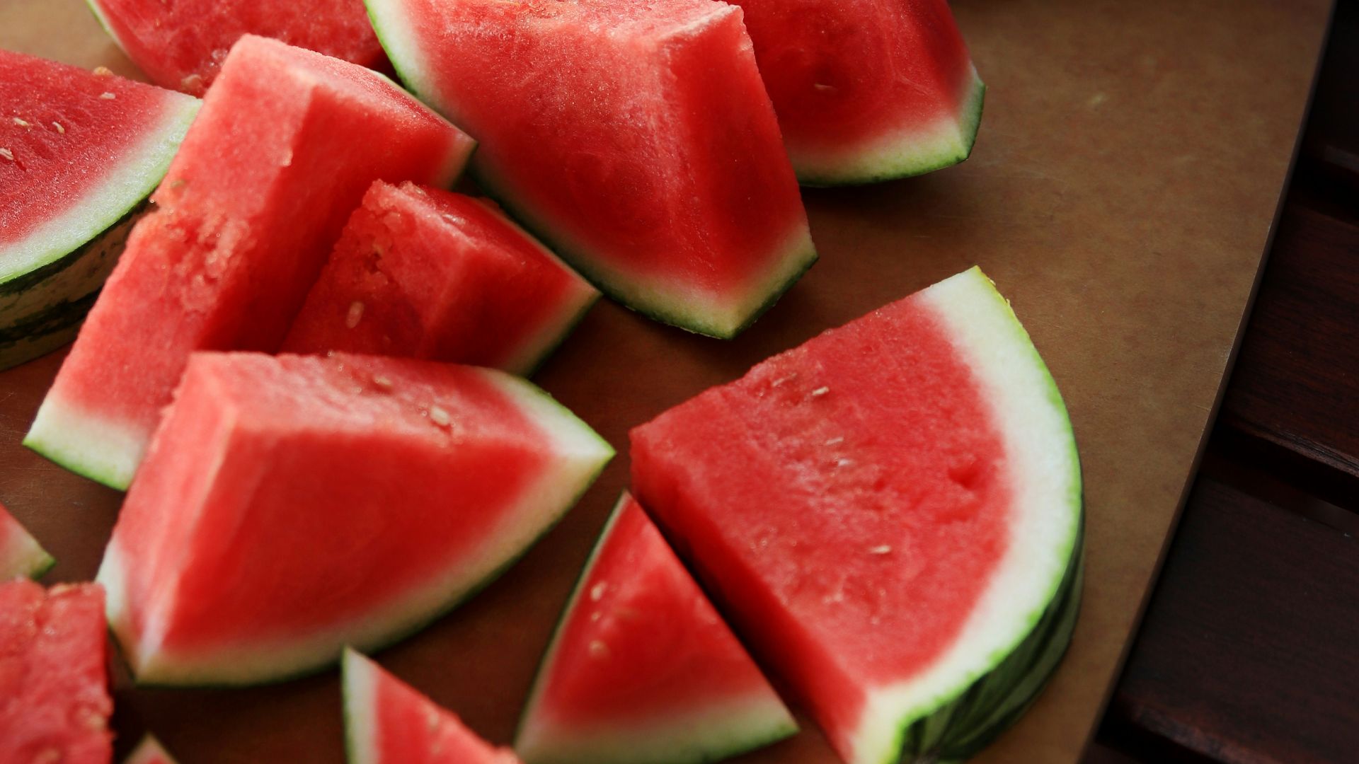 sliced watermelon on brown wooden chopping board