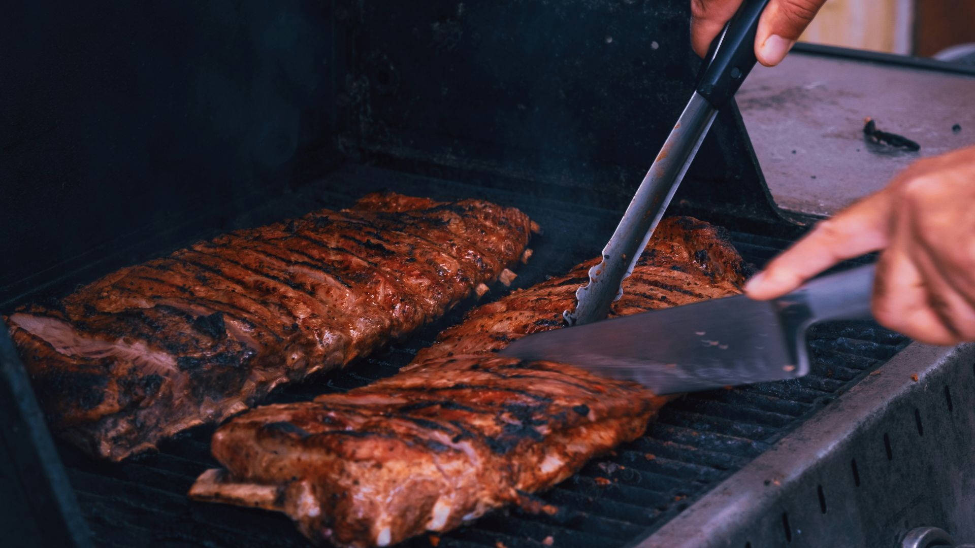 a man is grilling some meat on a grill