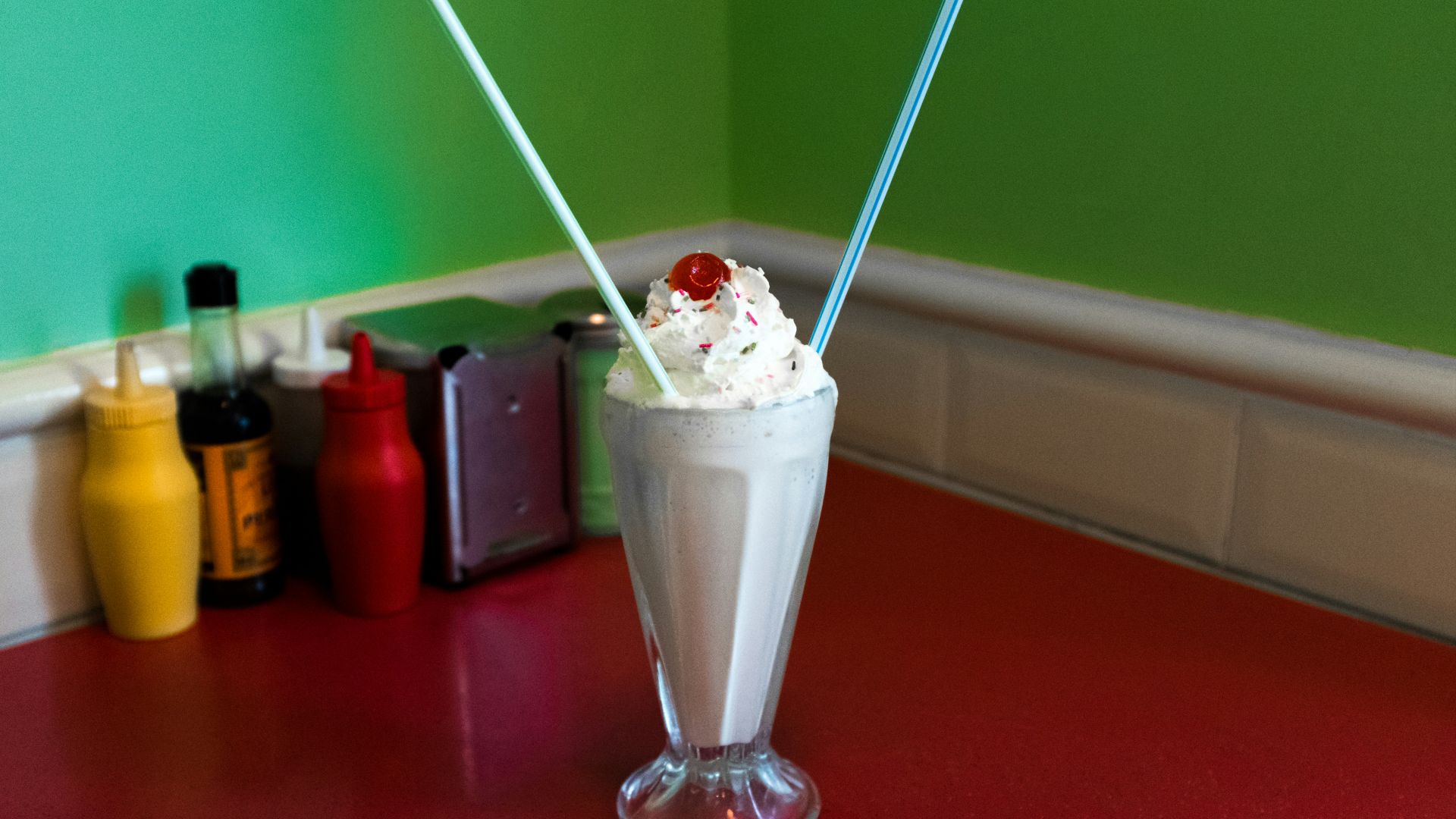 a cup of ice cream with a cherry on top