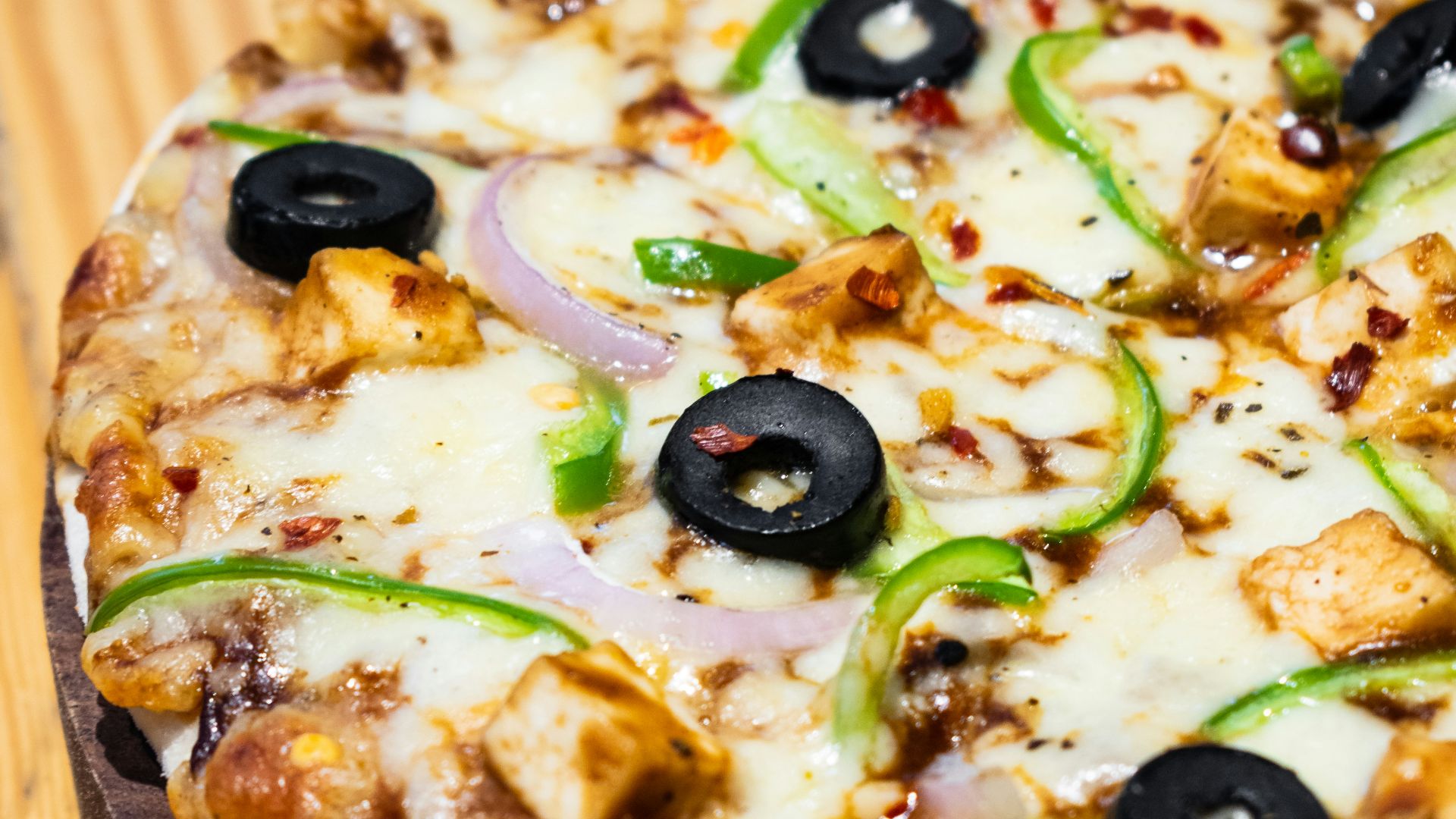 pizza with green and brown vegetable