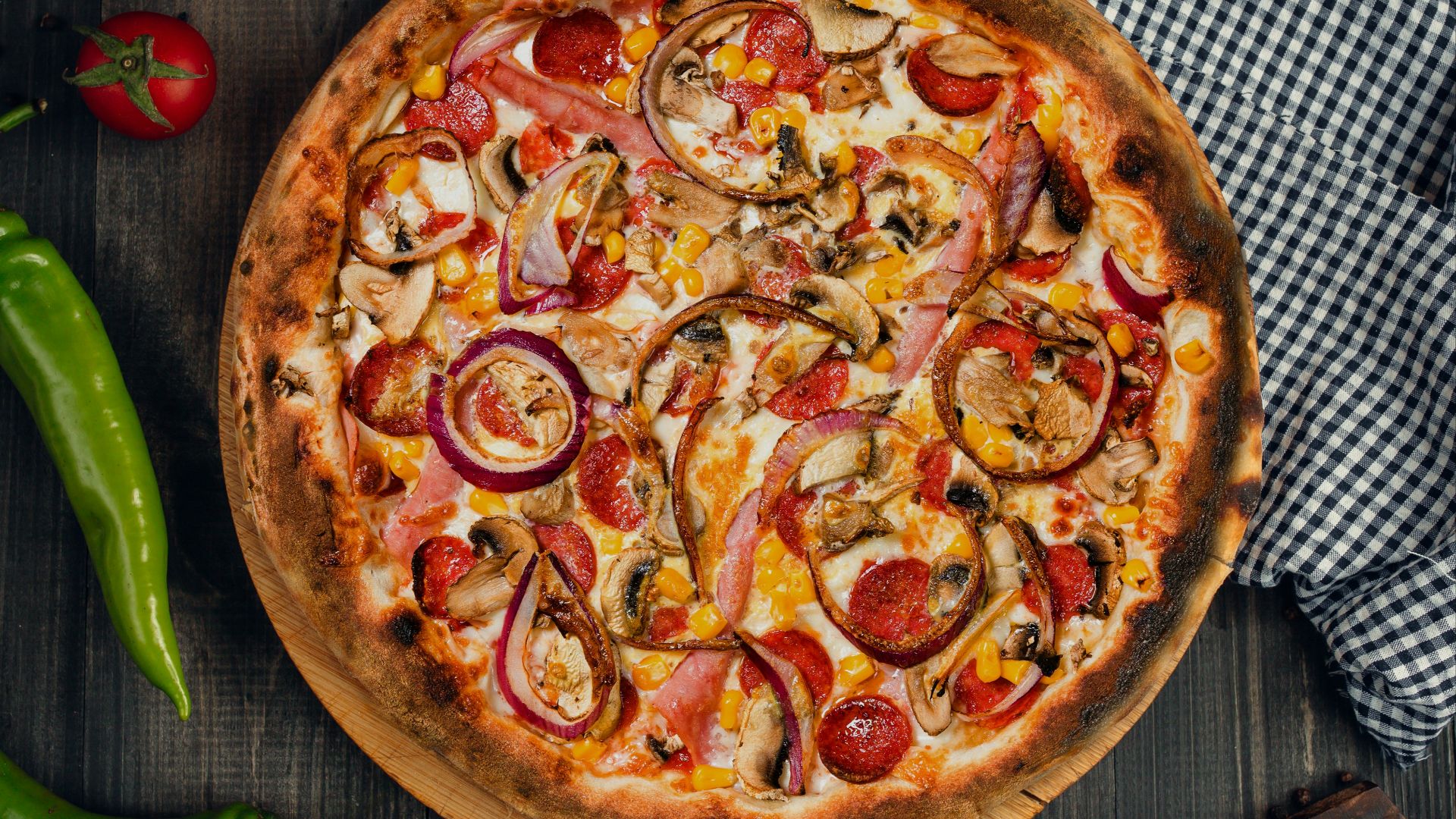 a pizza with tomatoes and onions