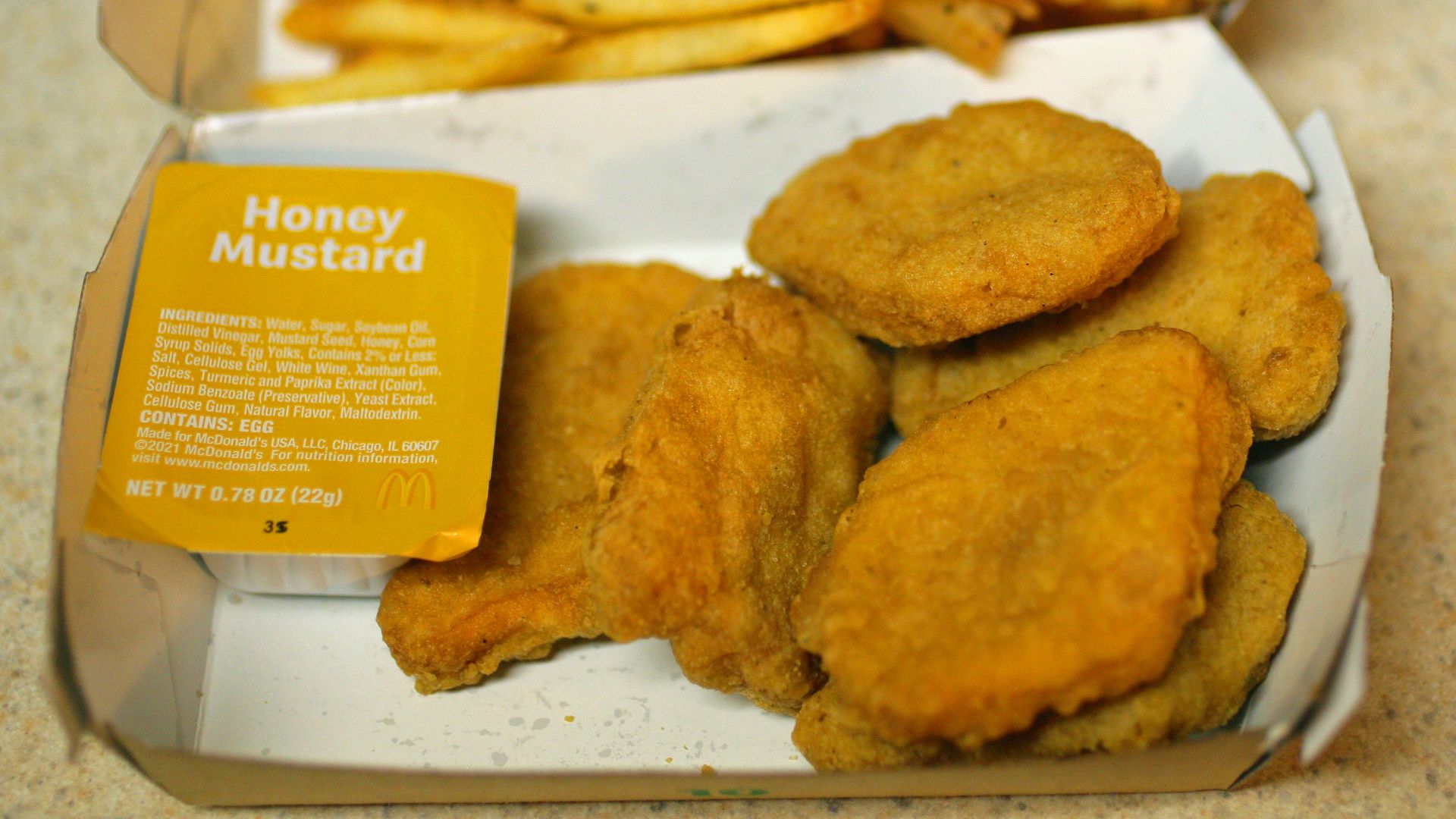 Mcdonald's chicken nuggets with fries.