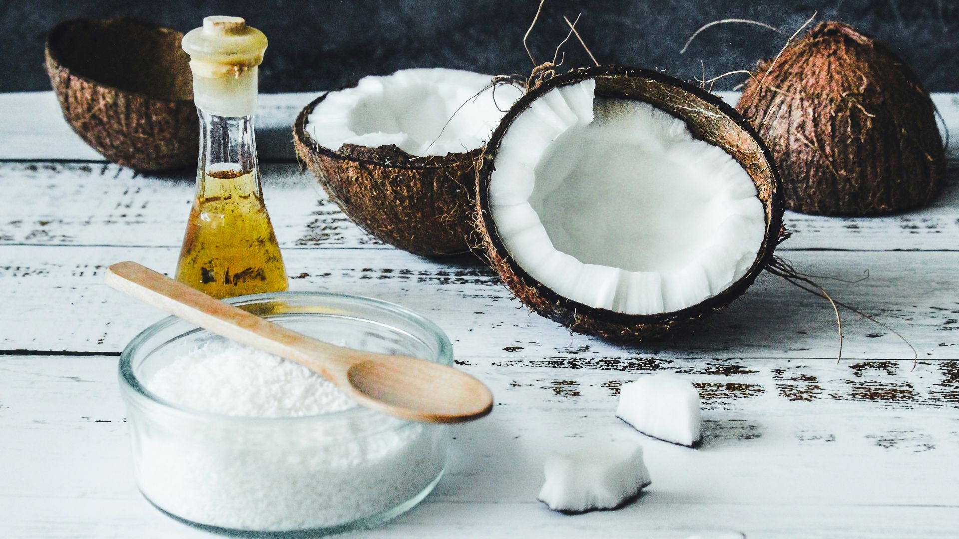 white powder in clear glass jar beside brown wooden spoon