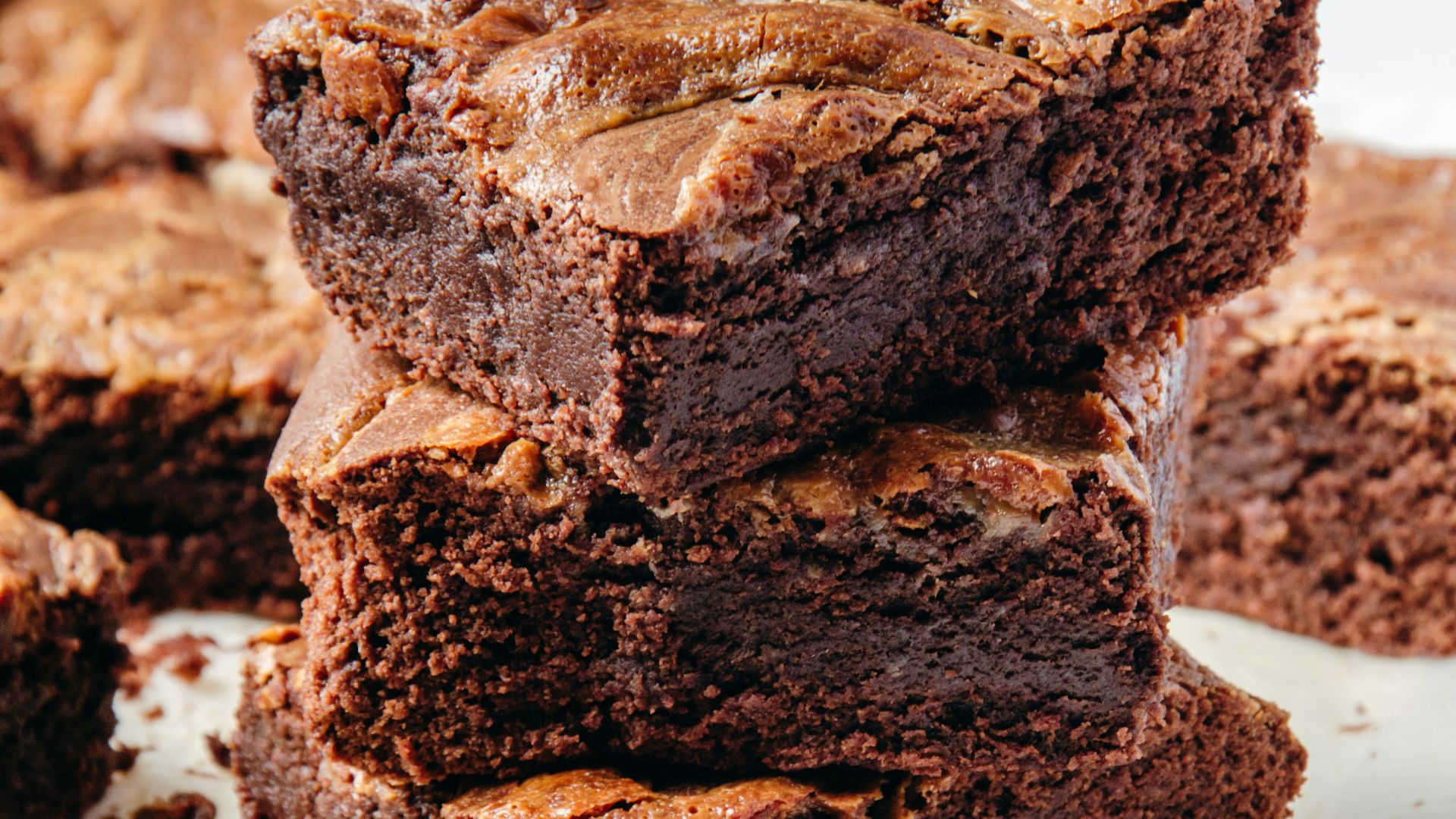 a pile of brownies sitting on top of a white plate