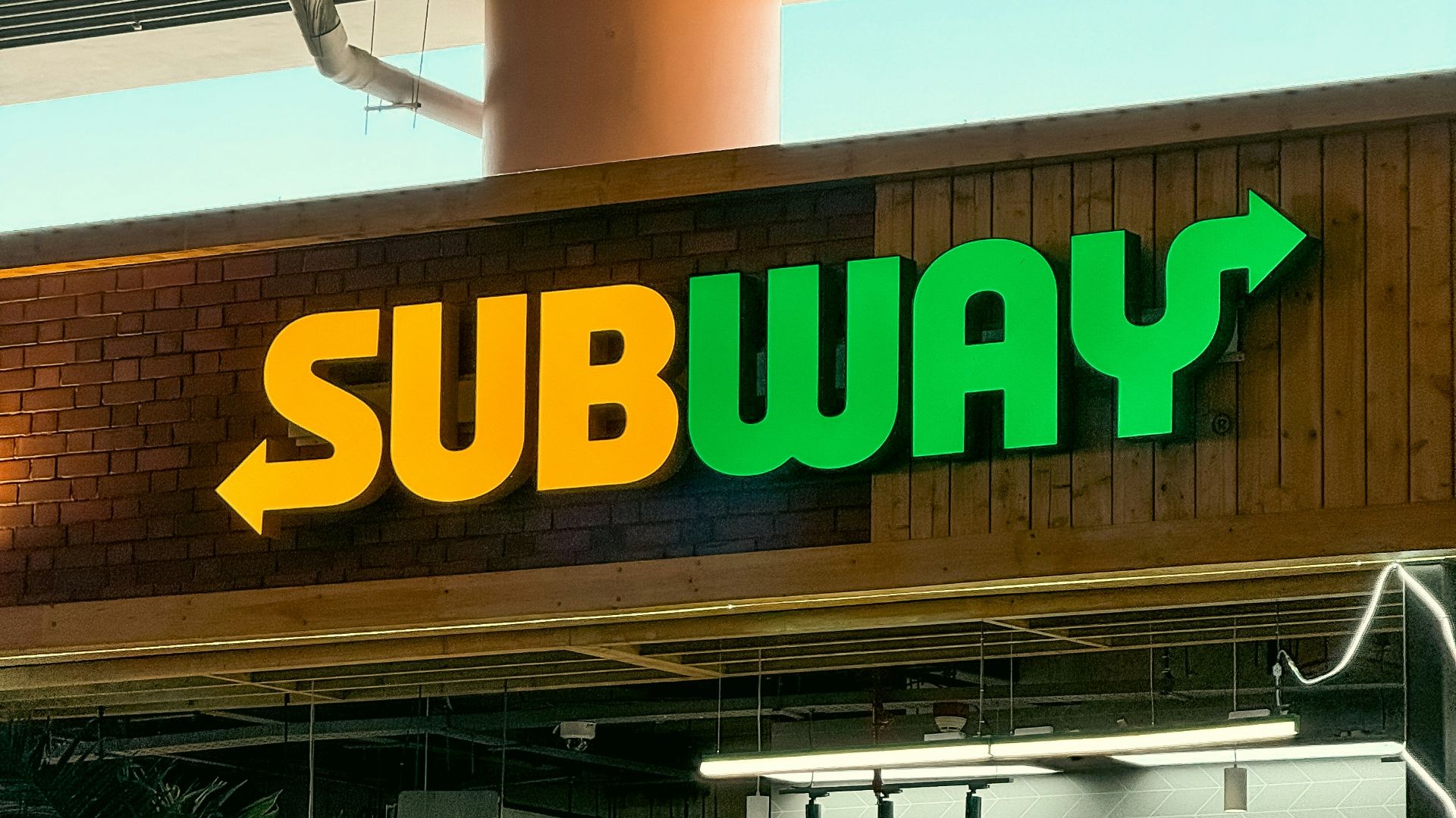 a subway sign above a subway entrance