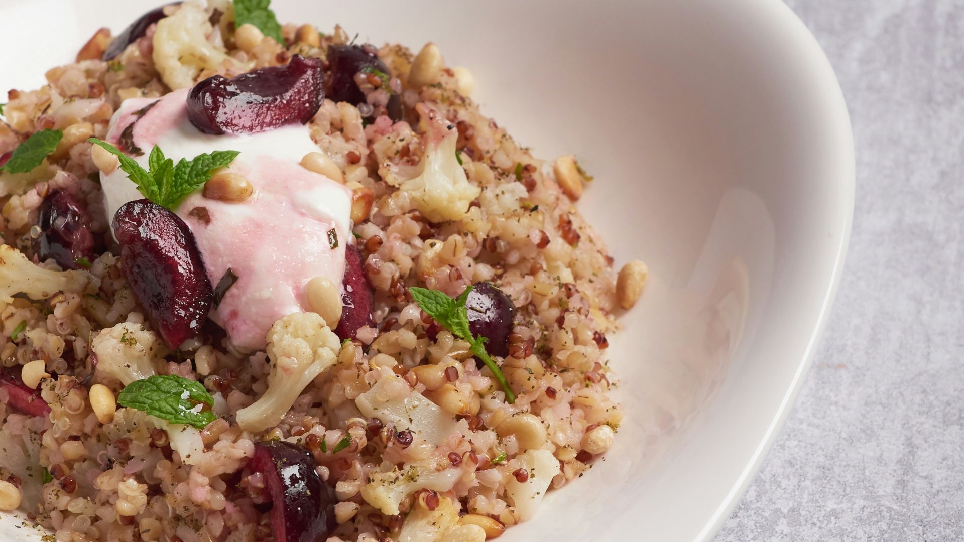 a white bowl filled with food on top of a table