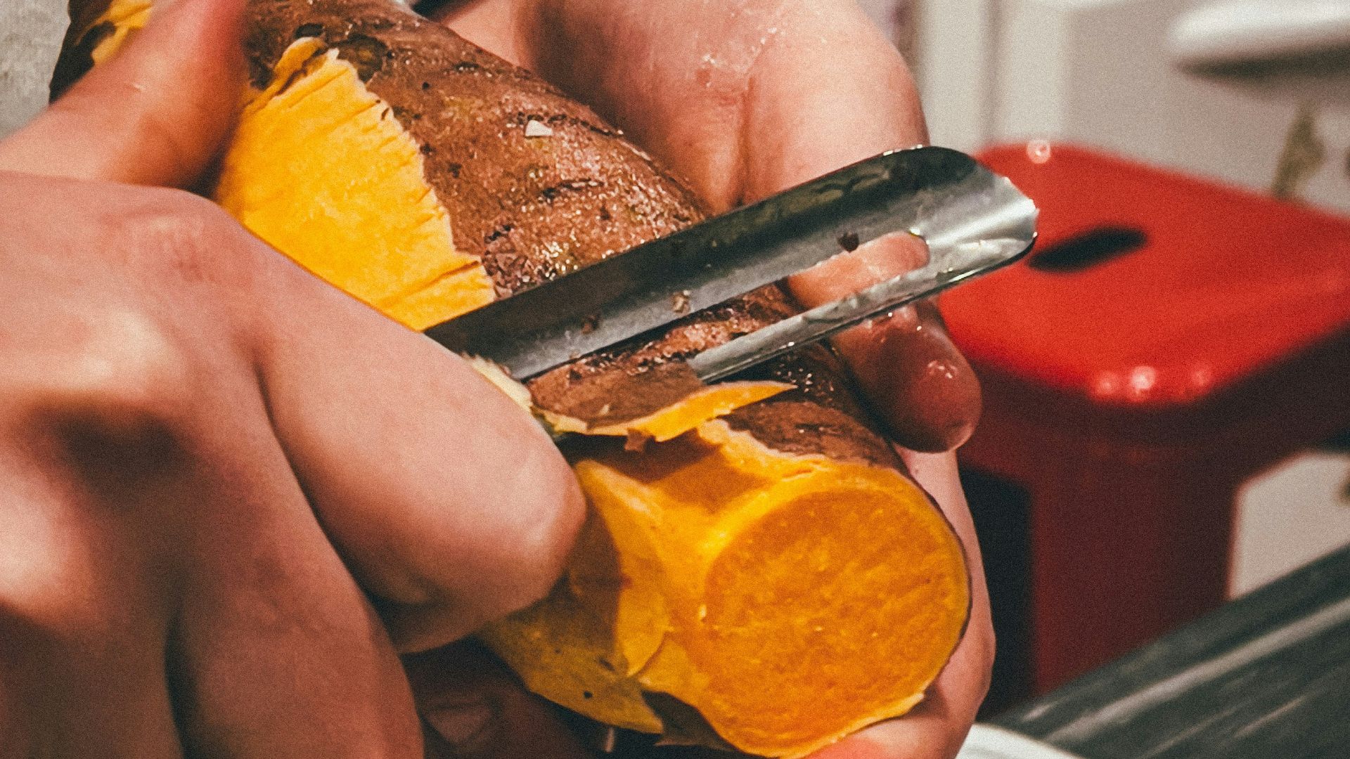 person holding sliced orange fruit