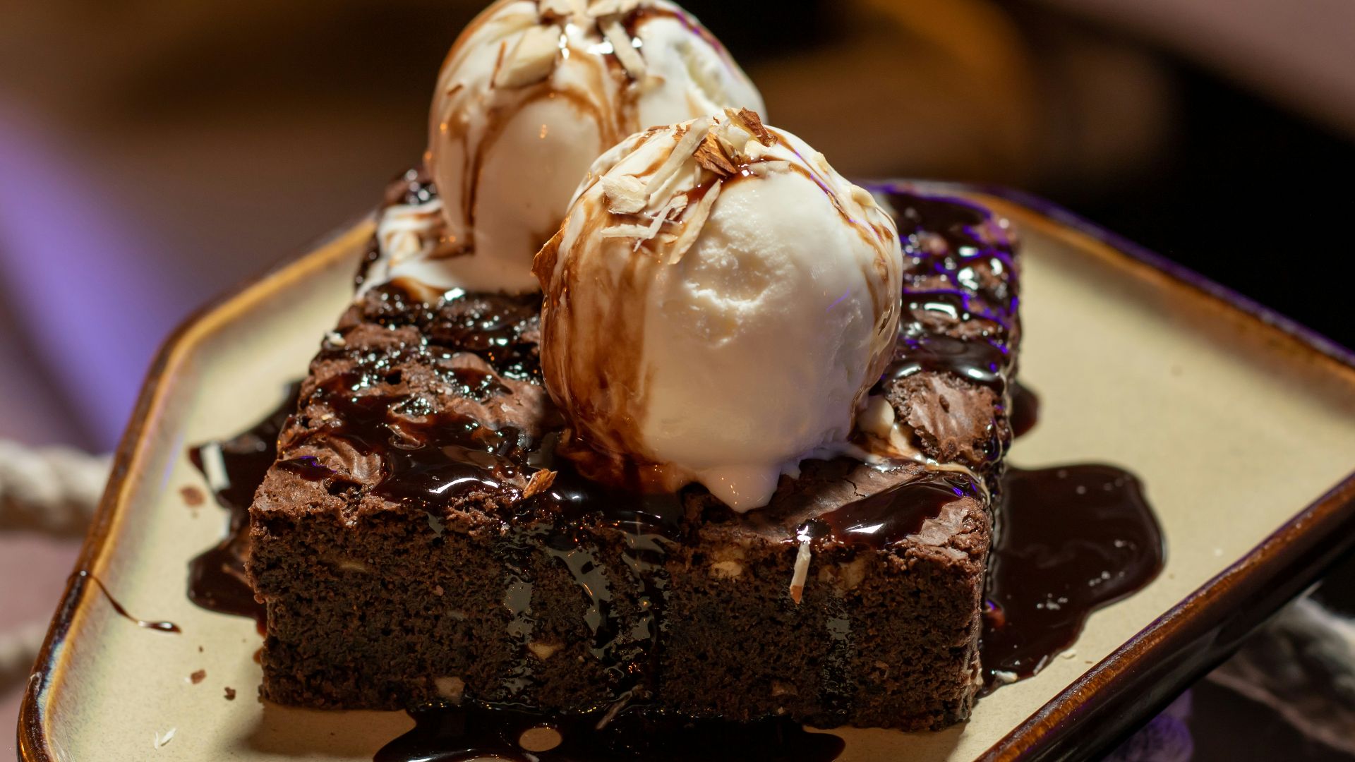 chocolate cake with white icing on white ceramic plate