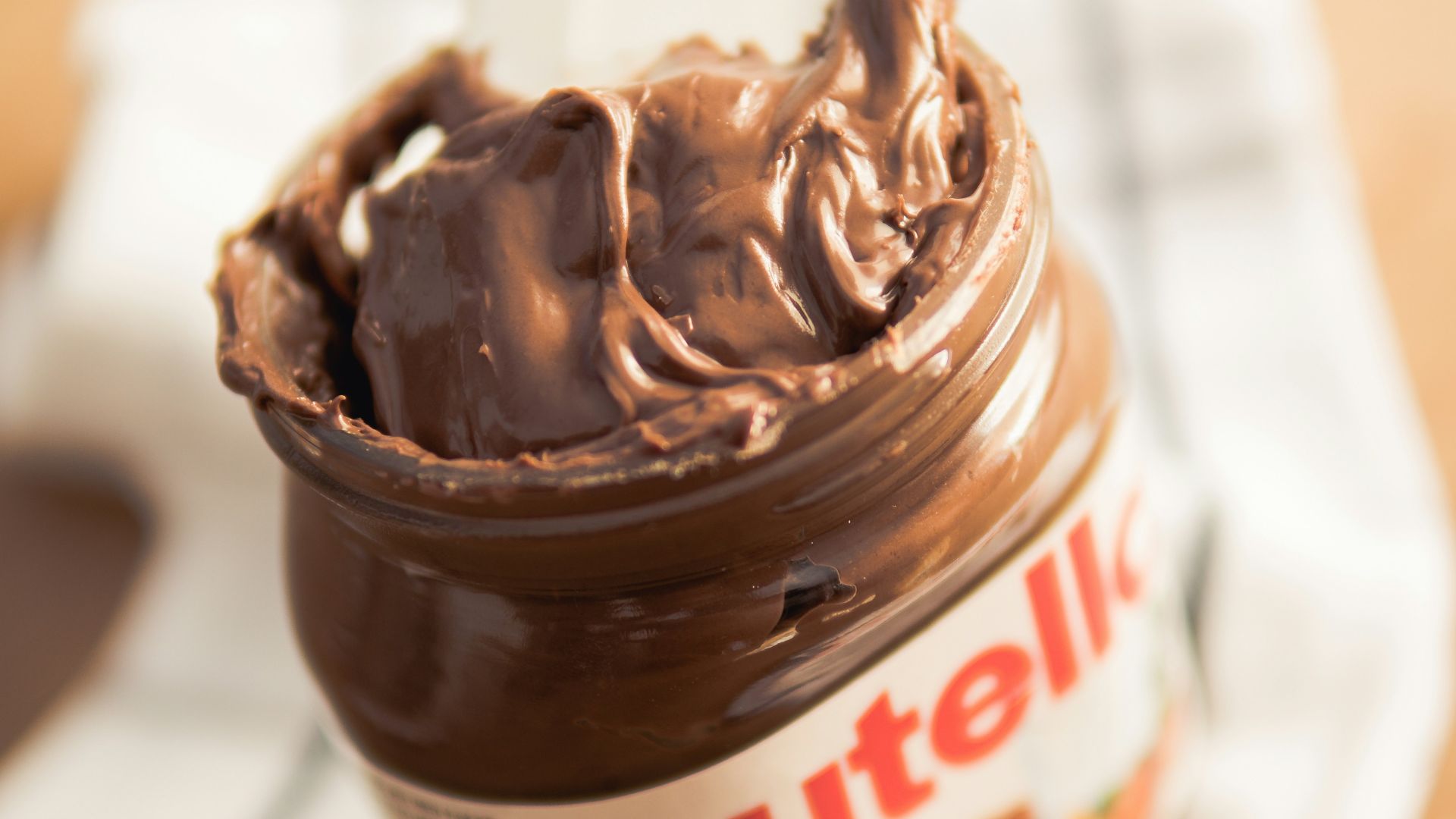 Nutella plastic container on white textile