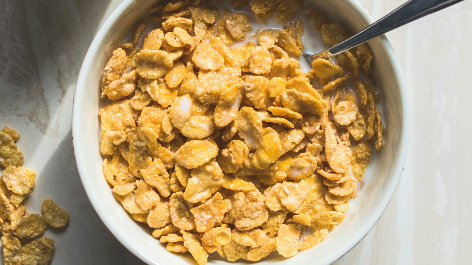ceramic bowl filled with cereals and spoon