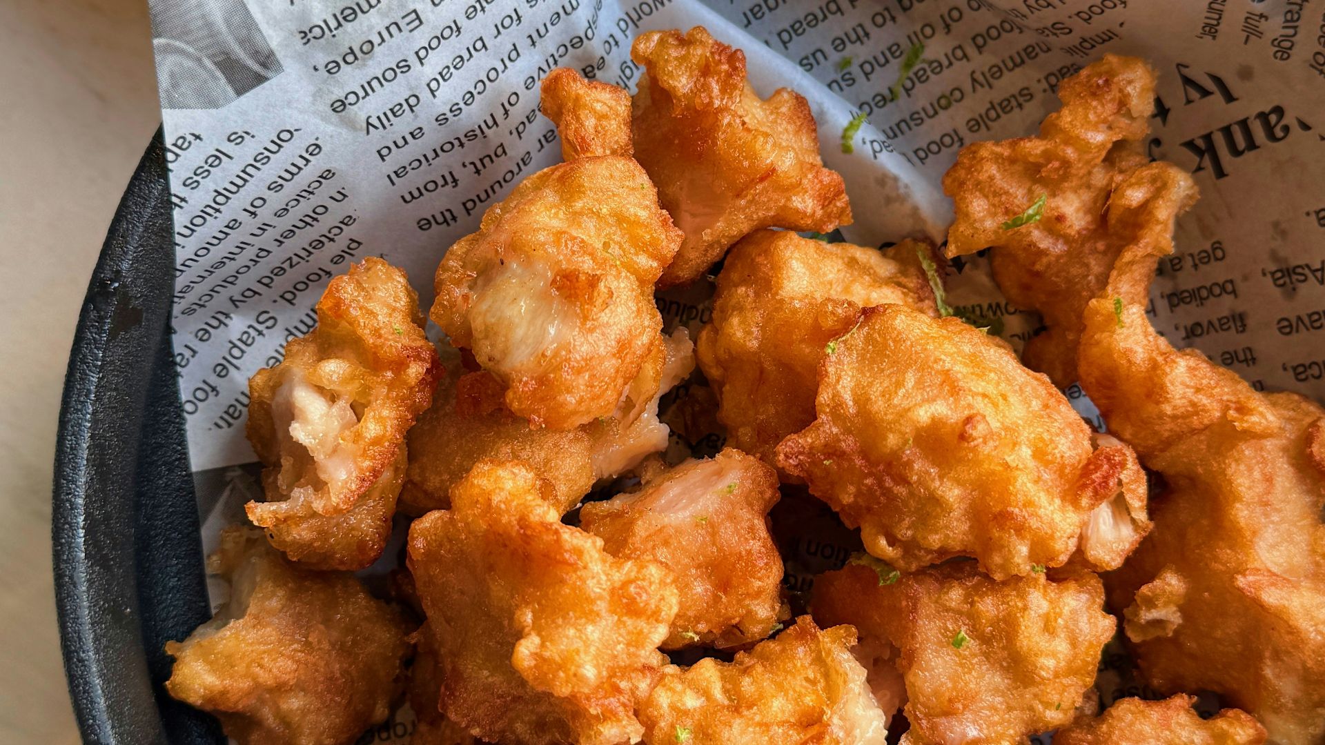 a bowl of fried food next to a bowl of mayonnaise