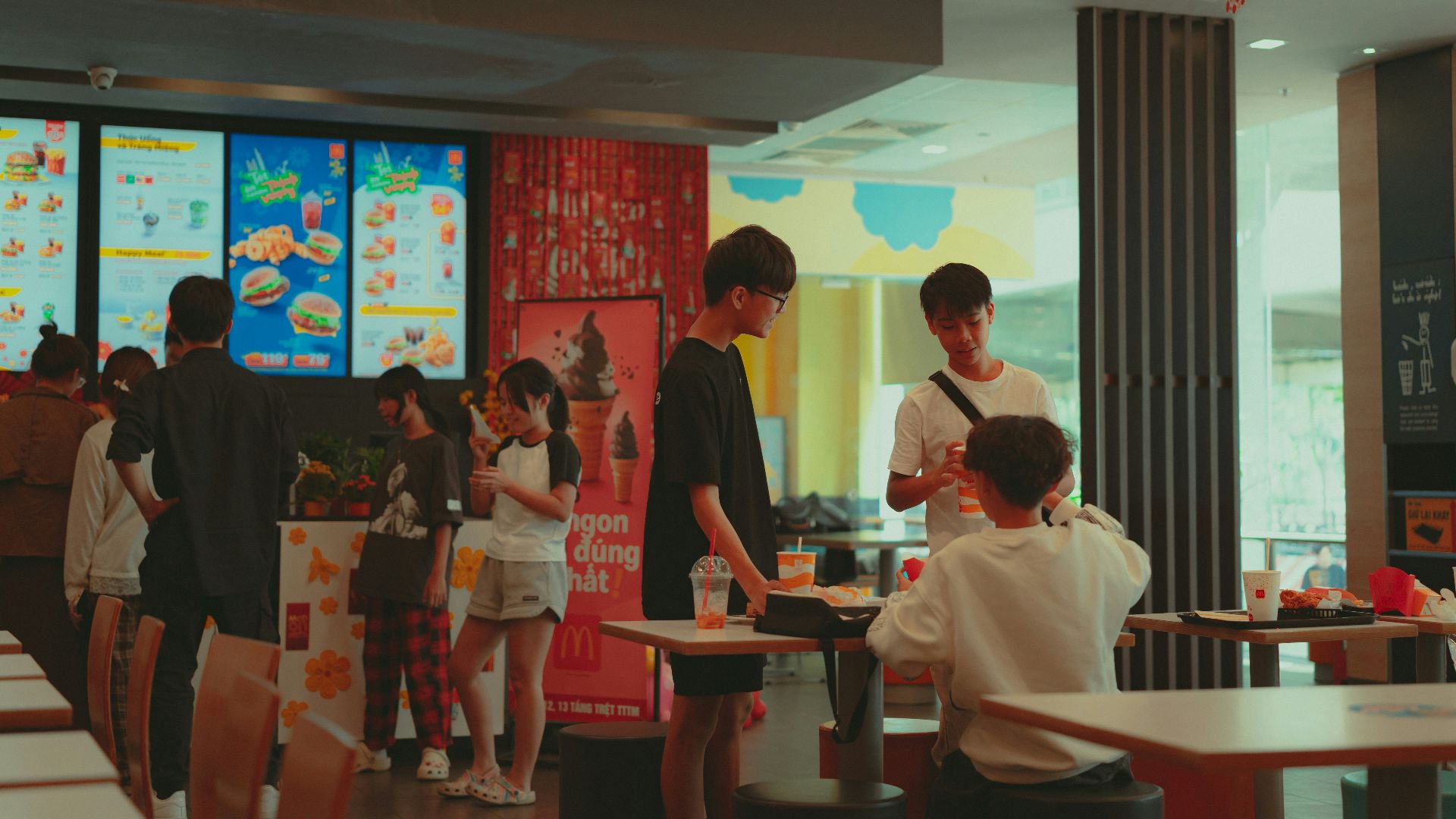 A group of people standing around a restaurant