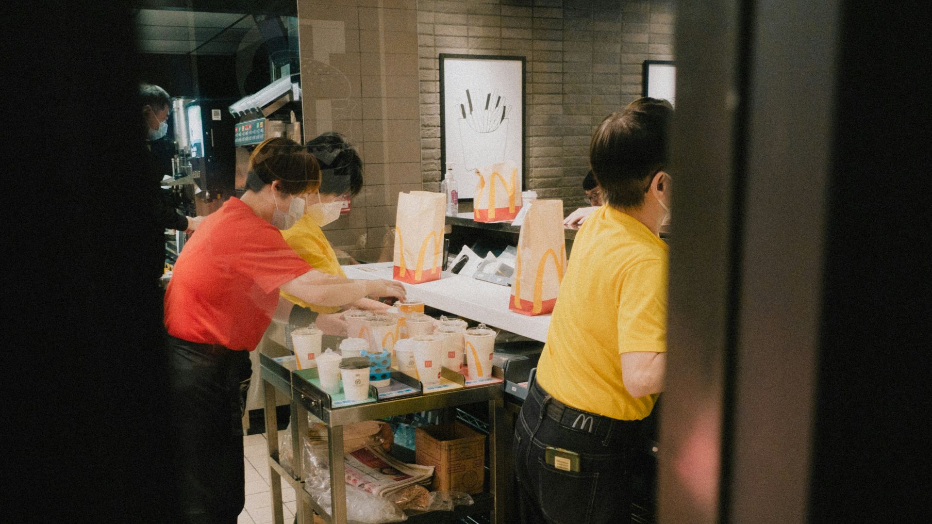 a couple of people that are standing in a kitchen
