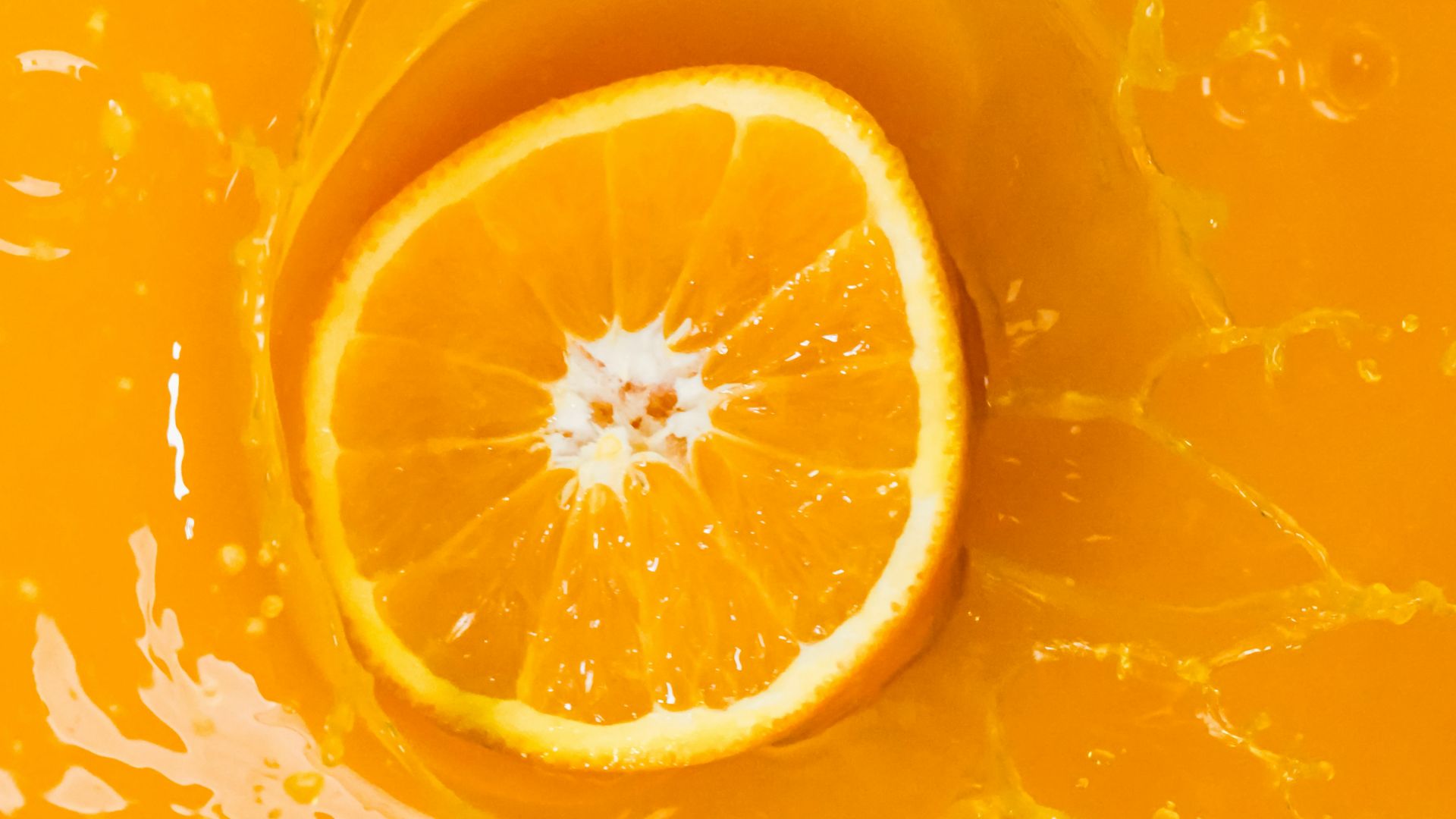a slice of orange sitting on top of a yellow bowl