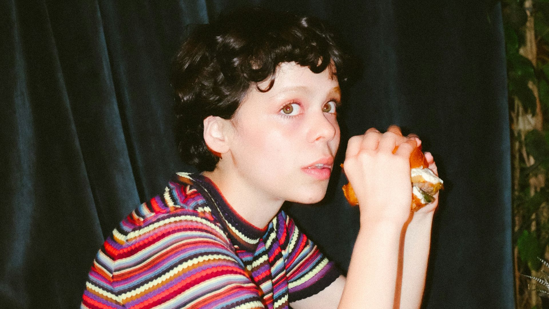 woman in red and white stripe shirt sitting on chair