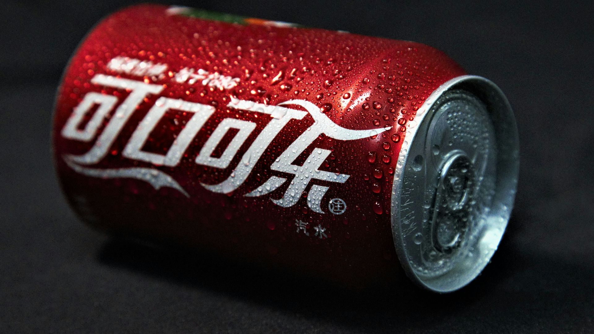 coca cola can on black textile