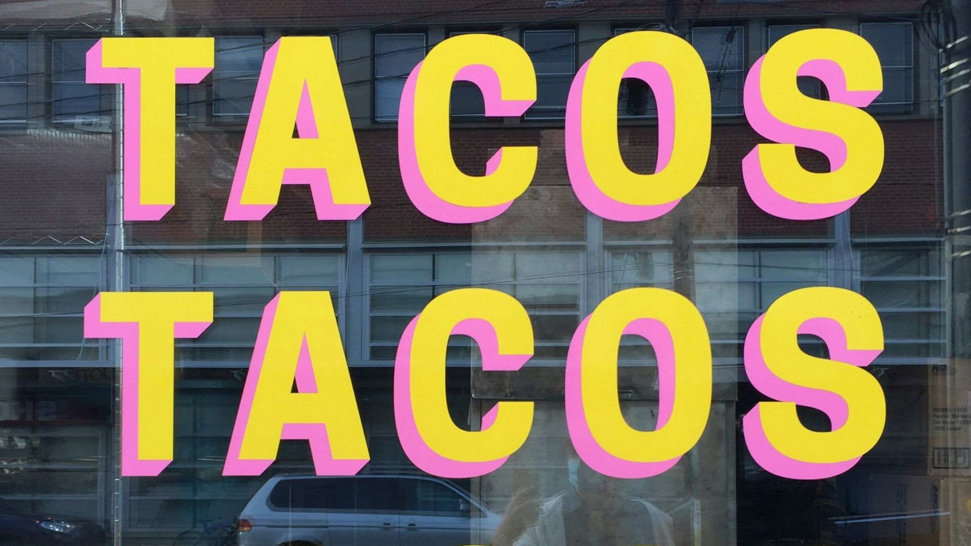 a window with a sign that says tacos tacos