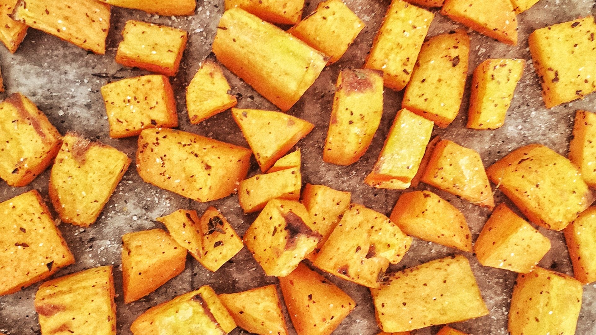 sliced orange fruits on brown wooden table