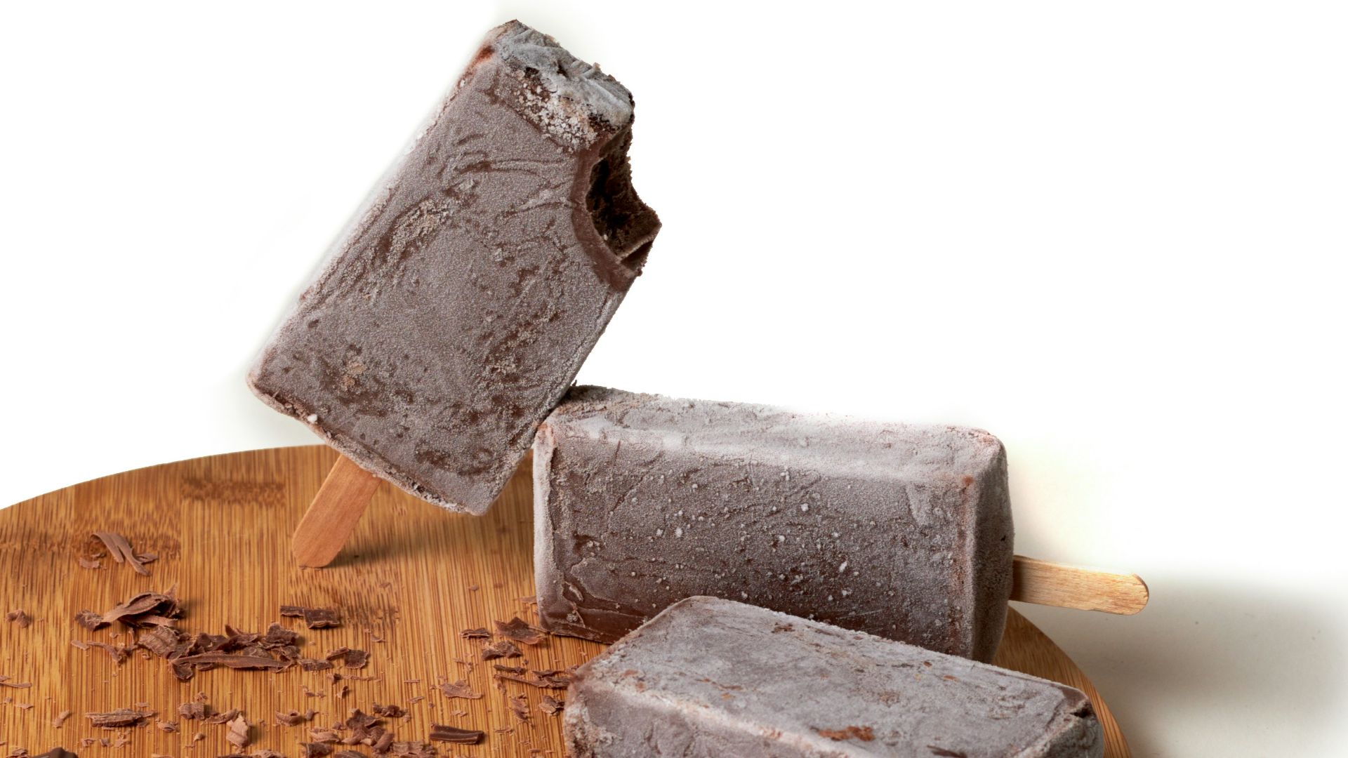 a couple of pops sitting on top of a wooden cutting board